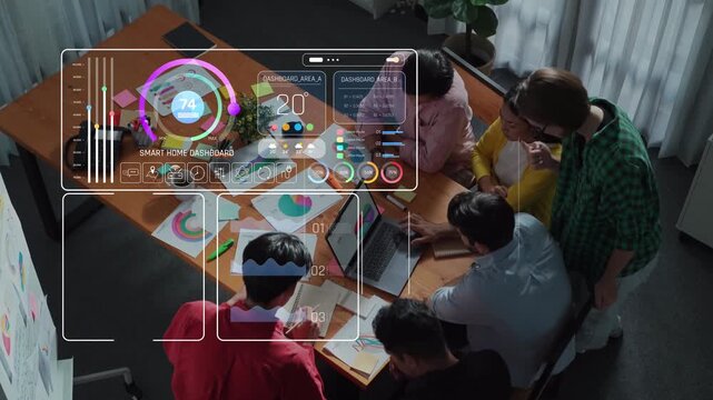 Aerial view of a modern workspace featuring a smart home dashboard with innovative data visualization and analytics, highlighting teamwork and productivity in a tech setting. Raster
