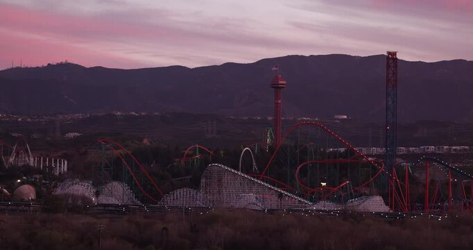 Valencia, California, USA - February 12, 2026: Evening lights illuminate the roller coasters and rides of Six Flags Magic Mountain.