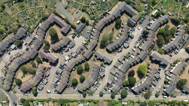 Aerial view of Dollis Hill, London, where dense residential housing meets community allotments in a typical suburban urban layout.