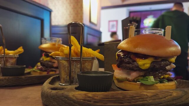 Delicious pub meal. Rustic setting featuring tasty cheeseburger and fries. Cozy pub scene with melted cheese burger and golden fries