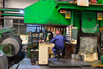 Fototapeta premium Workers on the production line of the strip steel coil factory are working