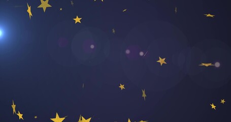 Glittering cluster of gold star confetti drifting across navy backdrop with bluish flare and bokeh