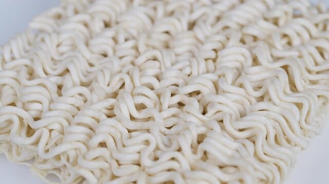 Uncooked ramen under soft lighting. Vivid image of springy noodle strands with pattern. Highdefinition macro photograph capturing intricate texture of dry ramen noodles