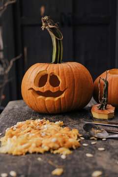 halloween pumpkin on a wooden table carved for a halloween party in October.