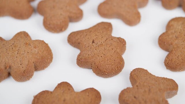 Gingerbread cookies pattern. Closeup of gingerbread cookies with festive patterns. Detailed view of gingerbread cookies arranged in rows with holiday warmth and charm