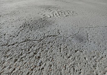 Rough gray concrete surface with cracks and texture