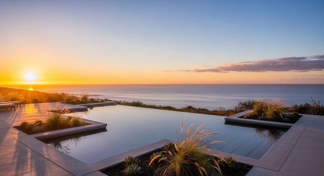 A modern infinity pool overlooking the ocean during a serene and vibrant sunset