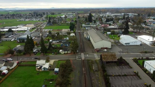 US, OR, Harrisburg, , 2025-11-23 - Drone view of the city of Harrisburg , over the railroad tracks flying south, in fall