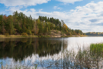 Fototapeta premium Rocky shores of Lake Ladoga near the village of Lumivaara on a sunny autumn day, Ladoga Skerries, Lahdenpohya, Republic of Karelia, Russia