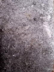 Obraz premium Close up of rough gray concrete surface with weathered stains and speckled texture, abstract background for construction, design, or grunge themes.