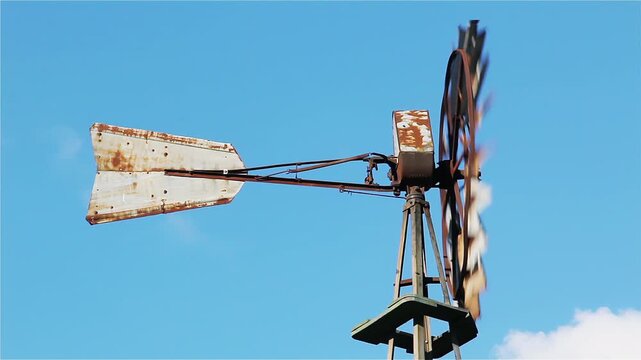 Rustic Metal Windmill Rotating Against Blue Sky, Rural Agriculture Water Pump - 4K