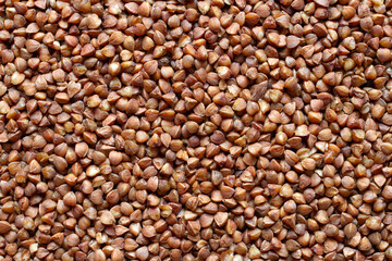The texture of natural buckwheat. Raw dry buckwheat close-up