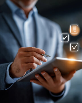 Smart Business Operations: A focused business person dressed in professional attire meticulously examines an online checklist using a modern tablet, the virtual check marks indicating task completion.