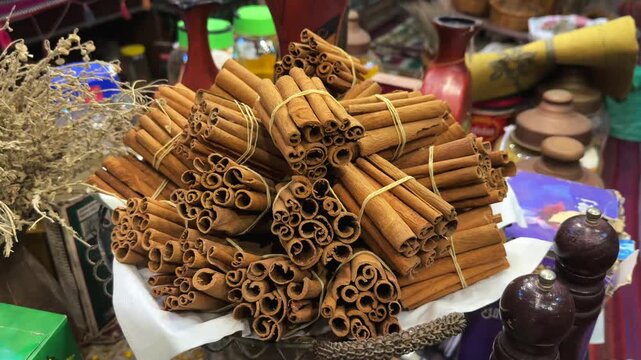 Cinnamon sticks tied and arranged in heap on bazaar table