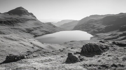 Serene mountain lake reflecting dramatic skies in a minimalist black and white landscape composition