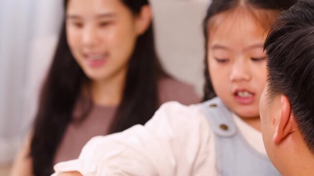 Close Up of Asian Family Interacting During Home Learning Activity