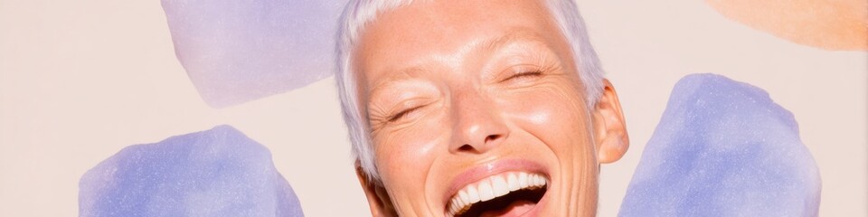 Fototapeta premium Mature senior woman with silver hair laughing and smiling in a beauty portrait for skincare and dental hygiene concepts on a soft off-white background with copy space