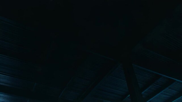 Spacious industrial warehouse interior with massive concrete columns, reflective puddles and blue atmospheric light filtering through foggy windows, evoking a vast, mysterious emptiness