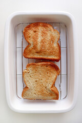Golden Toast Bread on Ceramic Oven Tray on White Background.