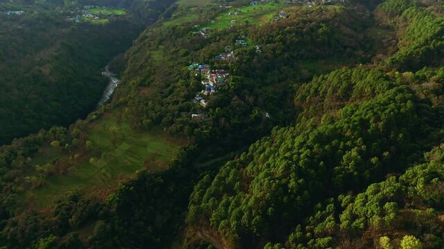 Drone view of small rural village nestled in middle of forest