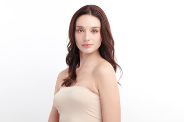 Obraz premium A beautiful young woman with clean, fresh skin against a white background. Skincare, facial treatment, cosmetology, beauty, and spa. An elegant portrait of an woman.