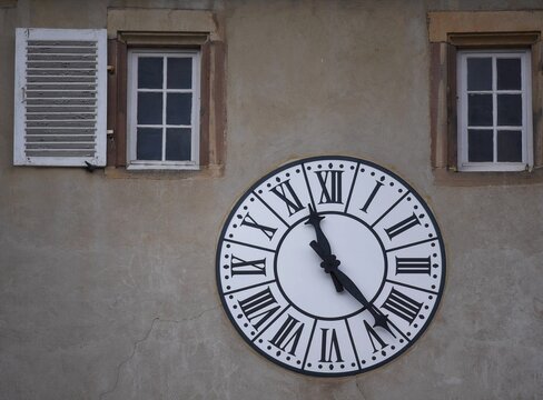 Antique clock on the facade of the medieval Port de la Vierge a historic monument of Rosheim in Alsace, France.