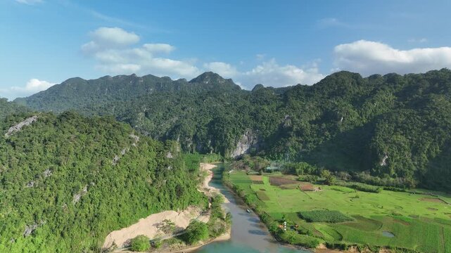 Phong Nha &ndash; Ke Bang National Park, Bo Trach, Quang Binh, Central Vietnam &ndash; 4K aerial footage of UNESCO Heritage site with Son River, limestone karst mountains, rice fields, tropical forest & cave