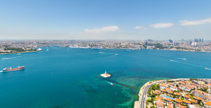 Istanbul, Turkey. Bosphorus with dry bulk carrier in Golden Horn inlet, view of Maiden's Tower, Fatih, Beyoglu and Uskudar districts. Aerial view at summer midday. Aerial view