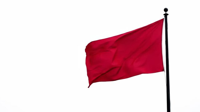 Red flag waving in sky isolated background