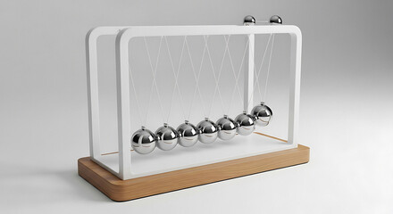 Newton's cradle with metal balls on a wooden base, illustrating kinetic energy and momentum in a serene, studio-lit environment