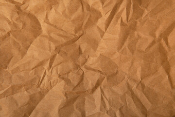 Obraz premium Creased wrap paper glow brown tone color texture background with space 
