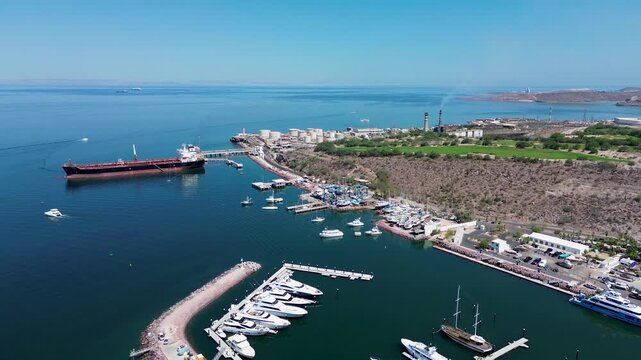 Frontal view of the industrial oil port and a golf courte in La Paz, BCS