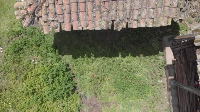 Wide view of an abandoned house in ambato near a road over a green grass terrain