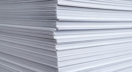 A close-up view of a neatly stacked pile of white paper sheets, showcasing the texture and layers of the material in a clean and organized presentation