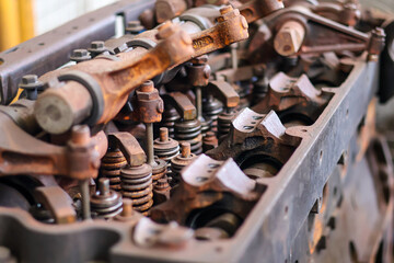 ​Close-up of rusty vintage engine valve train with rocker arms and springs in a mechanical workshop. © Jumain