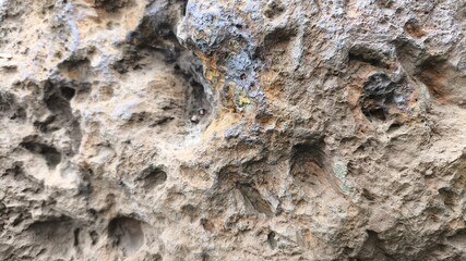 Rugged stone background featuring rough rock wall texture and weathered surface pattern, abstract natural material detail perfect for construction graphics and grunge backdrop design