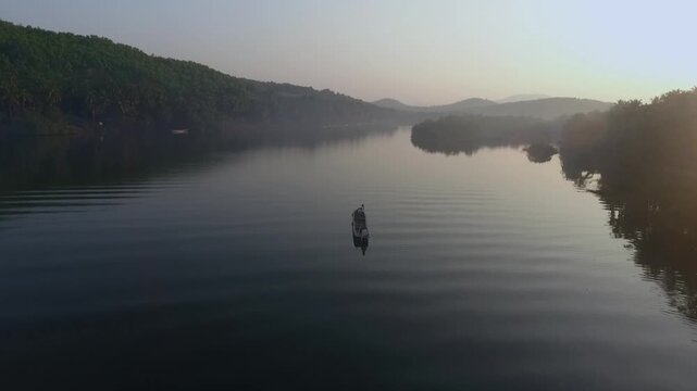 Aerial shot of a Boat on calm river Honnavar,Karnataka India