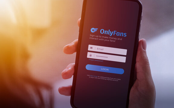 OnlyFans Login Screen Displayed on Smartphone Held in Hand
