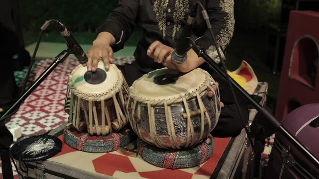 A shot of a man playing tabla at an Indian Wedding in New Delhi, India