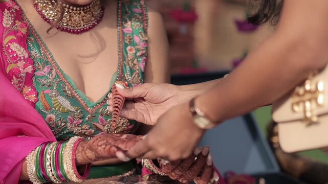 A Slow Motion Shot of Applying Mehndi on Bride's hand at her Indian Wedding in India