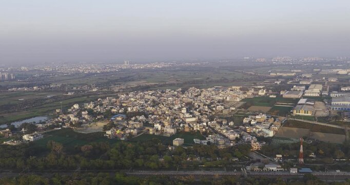 Aerial view of houses built in center of farm land in haryana 