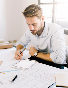 Architect working with tablet on desk