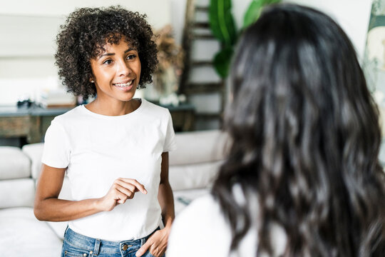 Portrait of smiling woman talking to a friend at home