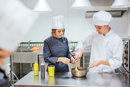 Junior chefs stirring chocolate sauce