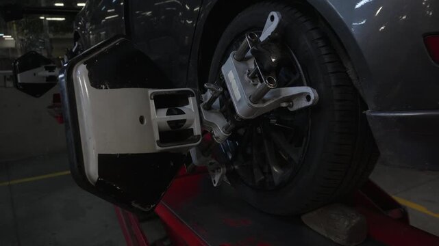 Car wheel with alignment sensor equipment in a mechanical workshop