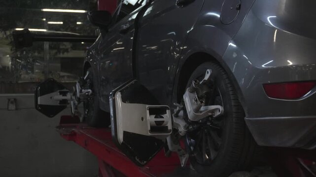 Car wheel with alignment sensor equipment in a mechanical workshop