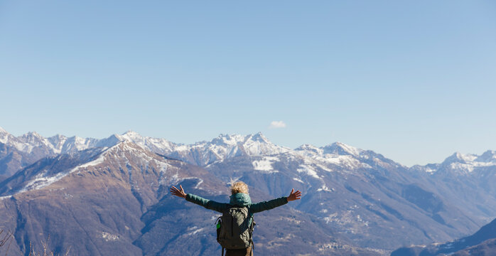 Italy, Como, woman on a hiking trip in the mountains enjoying the view