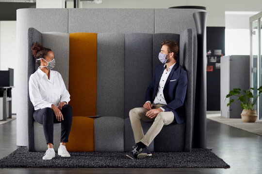 Colleagues keeping distance in office during Corona crisis