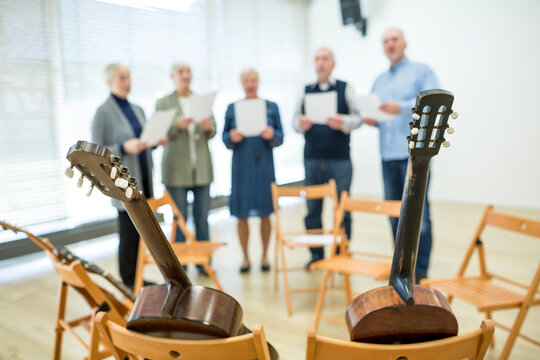 Seniors in retirement home making music singing in choir