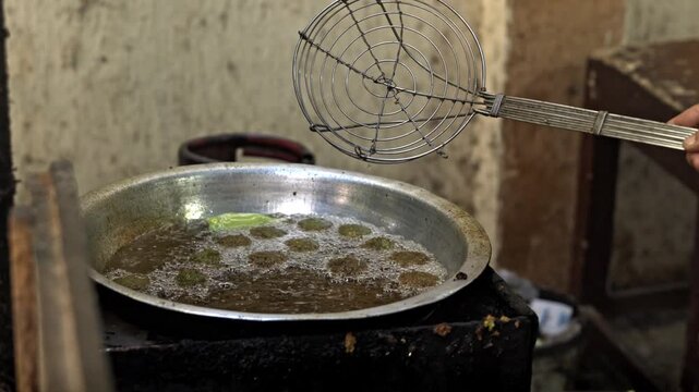 Hand-pressed Egyptian ta'ameya patties seasoned with vibrant red chili flakes and spices.
